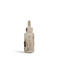 Dulcie Algae Plump Serum 30 mL bottle in shown in a decomposed state to illustrate material breakdown